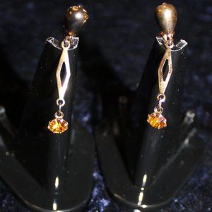 Gold tone dangle earrings with topaz stone